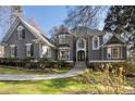 Beautiful home showcasing landscaped yard, stone accents, and elegant architectural details at 740 Frank Kirk Nw Rd, Kennesaw, GA 30152