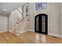 Bright foyer with elegant staircase, hardwood floors, and grand double doors with intricate designs at 740 Frank Kirk Nw Rd, Kennesaw, GA 30152