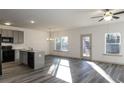 Open-concept living room featuring hardwood floors, modern lighting, and ample natural light at 325 Forkview Dr, Lawrenceville, GA 30044