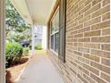 Classic brick exterior of home, framed with a view of greenery and the driveway at 1421 Gates Se Cir, Atlanta, GA 30316