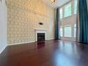 Bright living room features soaring ceilings, fireplace, and large windows with nice curtains at 1421 Gates Se Cir, Atlanta, GA 30316