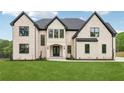 Elegant exterior with manicured lawn and large windows, showcasing a classic design at 1255 E M Croy Rd, Sugar Hill, GA 30518