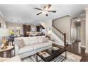 Open concept living room with hardwood floors, ceiling fan, and seamless transition to the dining and kitchen areas at 1370 Dupont Nw Park, Atlanta, GA 30318