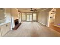 Living room view showcasing a fireplace, built-in bookshelves, and patio access at 2105 Ector Nw Cv, Kennesaw, GA 30152