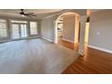 Spacious living room with hardwood accents, ceiling fan and archway to the kitchen at 2105 Ector Nw Cv, Kennesaw, GA 30152