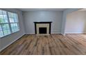 Bright living room with a fireplace, enhanced by natural light and new flooring at 359 Fourth St, Forest Park, GA 30297
