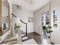 Bright foyer with hardwood floors, white walls, staircase, and a view to the outdoors at 3800 Wieuca Ne Ter, Atlanta, GA 30342