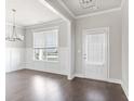 Bright living room featuring neutral paint, large window, and hardwood floors at 3927 Lockaby Way, Lawrenceville, GA 30044