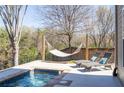 Backyard featuring a pool, hammock, lounge chairs, and a private outdoor space perfect for relaxation at 4664 Prater Se Way, Smyrna, GA 30080