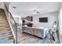 Open-concept living area with stairs, a plush couch, and a view of the kitchen at 6036 Oakley Rd, Union City, GA 30291