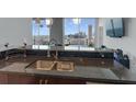 Enjoy city views from this modern kitchen with granite countertops and stainless sink at 400 W Peachtree Nw St # 2604, Atlanta, GA 30308
