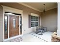 Covered front porch featuring a decorative pendant light, rocking chairs, and sidelight windows at 65 Turtle Rock Cv, Acworth, GA 30101