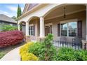 Inviting covered front porch with rocking chairs and decorative landscaping at 65 Turtle Rock Cv, Acworth, GA 30101