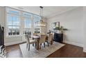 Elegant dining room with large windows, stylish chandelier, and hardwood floors for Gathering gatherings at 6682 Sterling Dr, Atlanta, GA 30328