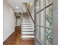 Bright entryway featuring hardwood floors, white stairs with dark trim, and natural light from the front door at 6682 Sterling Dr, Atlanta, GA 30328