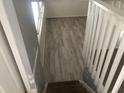 View down the staircase with white railings and light gray floors, providing a bright and modern feel at 6831 Lismore Dr, Norcross, GA 30093