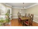 Elegant dining room features a large bay window, hardwood floors, and traditional decor at 210 Chiswick Close, Johns Creek, GA 30022