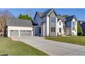 Beautiful home exterior featuring a wide driveway and a three-car garage at 2329 Walker Dr, Lawrenceville, GA 30043
