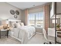 Serene bedroom with neutral tones, large window, and a dedicated workspace at 116 Asher Dr, Carrollton, GA 30116
