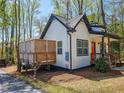 Charming two-story home with a wooden deck, bright orange door, and lush landscaping at 5728 Williams Rd, Norcross, GA 30093