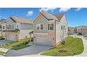 Charming two-story home featuring manicured lawn and two-car garage at 1566 Winding Ridge Trl, Hoschton, GA 30548