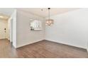 The dining area features a modern chandelier and an opening providing a view into the kitchen at 808 Riverview Se Dr, Marietta, GA 30067