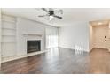 Spacious living room with a fireplace, built-in shelving, dark wood-look floors, and sliding glass door at 808 Riverview Se Dr, Marietta, GA 30067