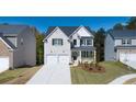 Charming craftsman-style home features a brick facade, two-car garage, and manicured lawn at 1871 Lacebark Elm Way, Lawrenceville, GA 30045