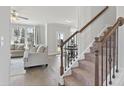 Carpeted stairs with stained wood and iron banister lead to the living room and dining area at 3936 Lockaby Way, Lawrenceville, GA 30044