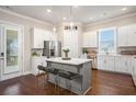 Modern kitchen with white cabinets, stainless steel appliances, a center island, and hardwood floors at 3139 Hilltop Dr, Marietta, GA 30066