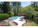 Lounge by the pool with stone deck with a beautiful wooded view, perfect for relaxation and entertainment at 948 Saint Lyonn Cts, Marietta, GA 30068