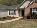 Charming front entrance featuring well-maintained landscaping at 4580 Darrowby Dr, Powder Springs, GA 30127