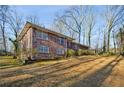 A spacious brick home with a sprawling yard and mature trees, perfect for outdoor enjoyment at 1237 Samuel St, Marietta, GA 30008