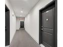 Well-lit hallway with neutral carpeting and doors, featuring unit numbers for easy navigation at 2230 Cheshire Bridge Ne Rd # 410, Atlanta, GA 30324