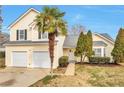 Charming two-story home with attached two-car garage and beautifully landscaped front yard at 4410 Millenium View Ct, Snellville, GA 30039