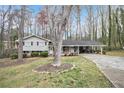 Inviting one-story home with a manicured lawn, a covered parking area and mature trees at 5140 Cowart Ct, Powder Springs, GA 30127