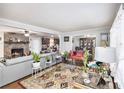 Spacious living room featuring a brick fireplace and an open floor plan leading to the dining and kitchen areas at 5140 Cowart Ct, Powder Springs, GA 30127