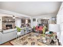 Inviting living room features a brick fireplace, ceiling fan, and seamlessly connects to the dining and kitchen areas at 5140 Cowart Ct, Powder Springs, GA 30127