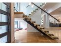 Bright entryway featuring modern stairs with glass railings and floor to ceiling windows at 1653 Pamela Ne Dr, Brookhaven, GA 30319