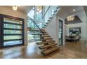 Bright entryway featuring modern stairs with glass railings and floor to ceiling windows at 1653 Pamela Ne Dr, Brookhaven, GA 30319