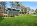 Attractive gray brick home with a spacious yard and manicured shrubbery at 3048 San Jose Dr, Decatur, GA 30032