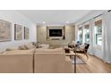 Bright living room featuring custom built-ins, a large TV, and modern decor for a cozy atmosphere at 6530 Lantana Village Way, Cumming, GA 30028