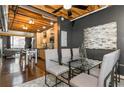 Open-concept dining area with a glass table, seating for four, and stainless steel kitchen nearby at 1661 La France Ne St # 314, Atlanta, GA 30307