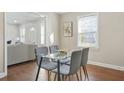 Cozy dining area featuring hardwood floors and a glass-top table with seating for four at 1013 Columbia Dr, Decatur, GA 30030