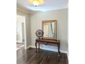 Elegant entryway featuring dark hardwood floors and an ornate table with a decorative mirror at 3655 Brisbane Dr, Marietta, GA 30062