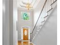 Elegant foyer with high ceilings, chandelier, staircase, and hardwood flooring, creating a grand entrance at 3655 Brisbane Dr, Marietta, GA 30062
