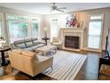 Comfortable living room with a fireplace, neutral paint, hardwood floors, and ample natural light at 3655 Brisbane Dr, Marietta, GA 30062