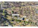 Aerial view of a large lot with house, detached garage and pool at 5595 Rolling Acres Ln, Cumming, GA 30028