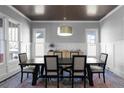 A dining room with an eye-catching modern chandelier and a large table set for six sits on a colorful rug at 2019 Mason Mill Rd, Decatur, GA 30033
