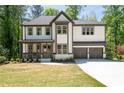 Beautiful exterior view of a two-story home with gray trim, white siding, and a covered front porch at 2848 Tanner Lake Nw Trl, Marietta, GA 30064